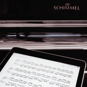 iPad with digital sheet music and Schimmel piano